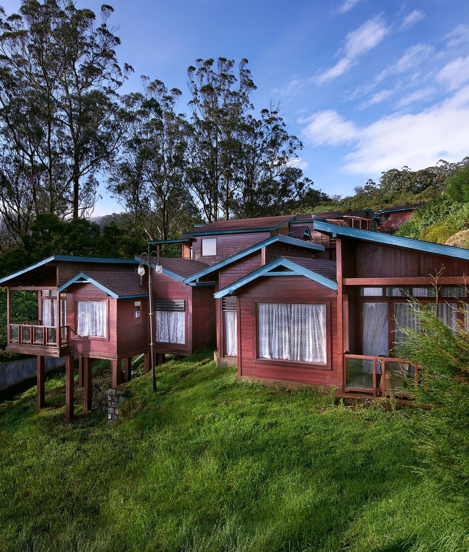 An image of a villa set amidst the hills filled with plants and trees - Accord Hotels and Resorts